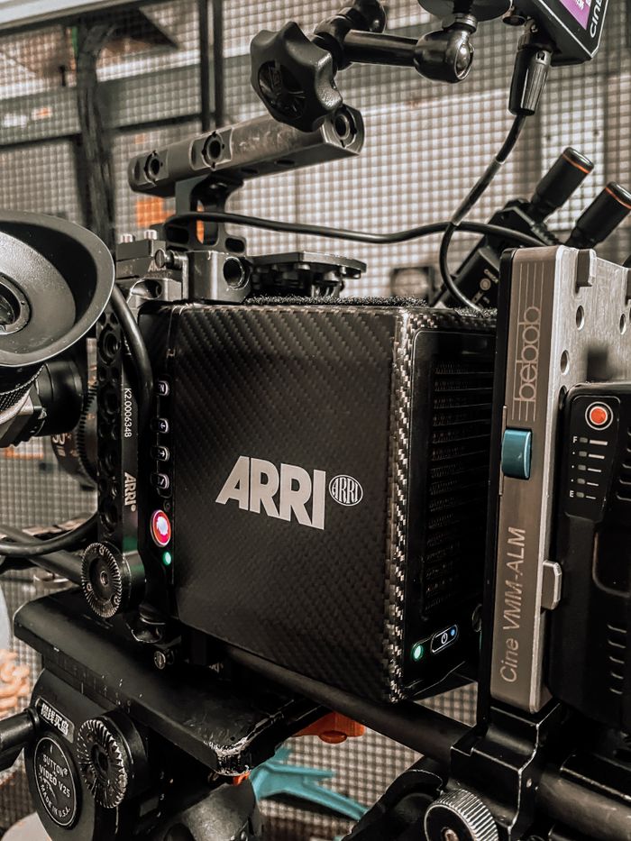 Close-up of a professional ARRI camera rigged for filming in a modern studio.
